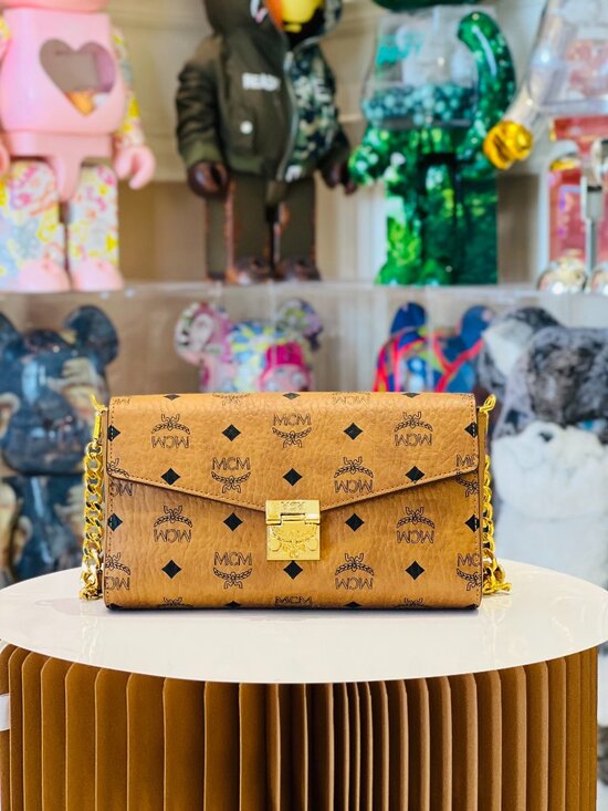 MCM Handbags - MCM Tan Monogram Clutch with Gold Accent